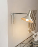 Adjustable wall lamp with movable arm